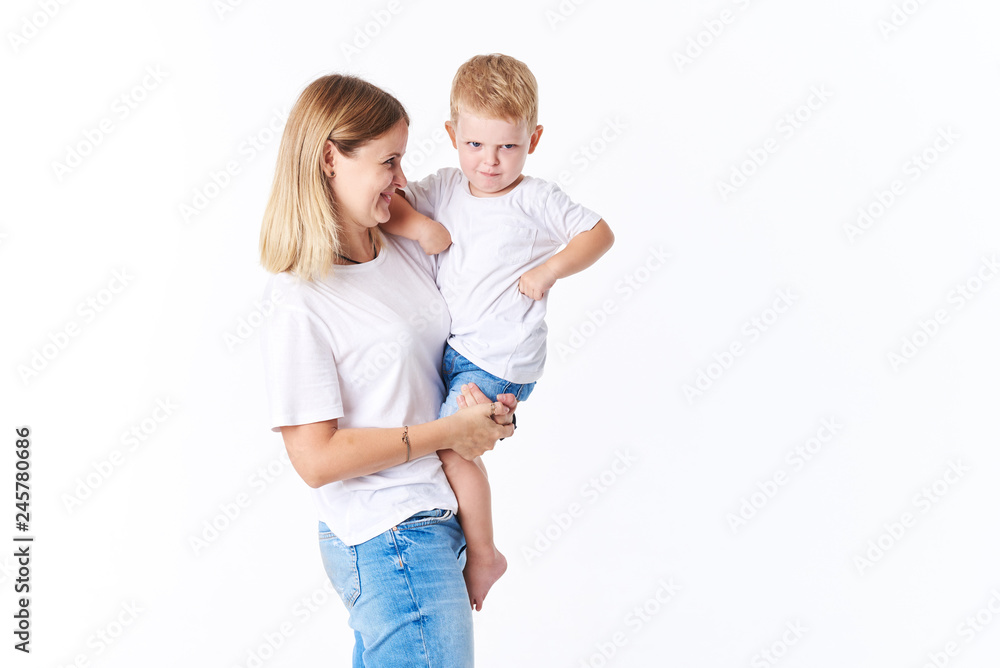 Beautiful smimling young mother with her toddler son (real family). Isolated on white background. Beautiful smimling young mother with her toddler son (real family). Isolated on white background.