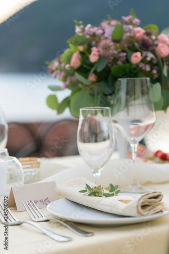 table decorated with fresh flowers for an outdoor wedding dinner