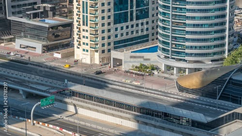 Aerial view of Dubai Tram in Dubai marina timelapse. Dubai Tram runs in a loop around Marina and JBR area and links up with the Dubai Metro and the Palm Monorail. photo