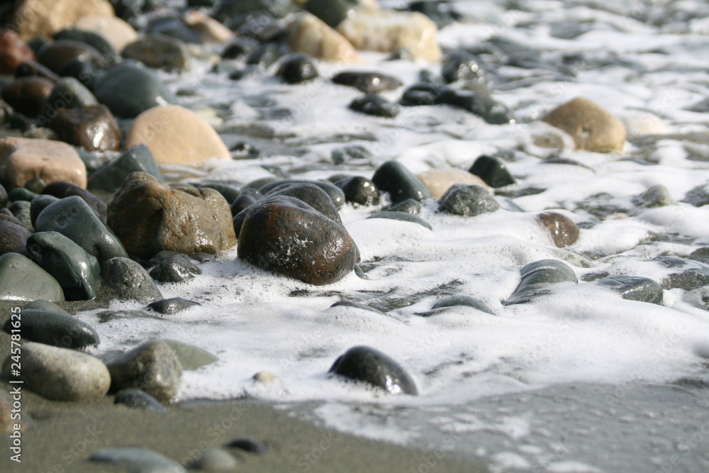Stones and sea water on a beach Stones and sea water on a beach