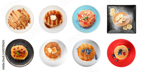 Set of plates with delicious pancakes and different toppings on white background  top view