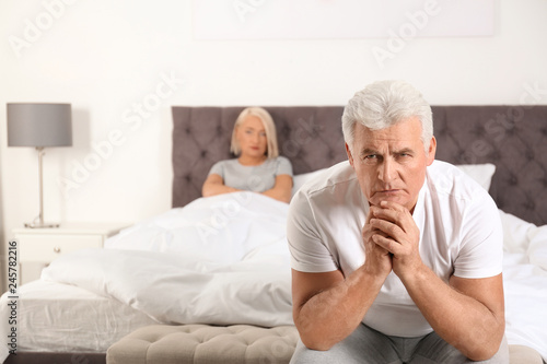 Senior man having conflict with his wife in bedroom. Relationship problems