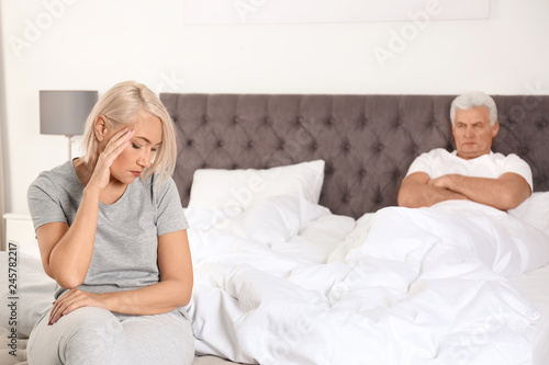 Senior woman having conflict with her husband in bedroom. Relationship problems