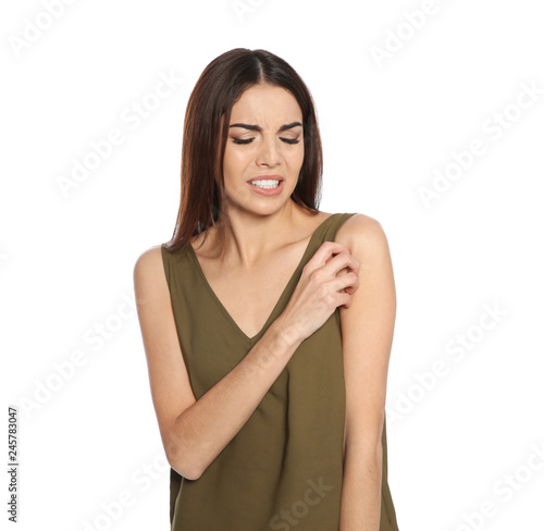 Young woman scratching skin on white background. Annoying itch