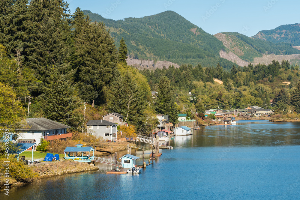 Houses, piers and boats on a shore of a lagoon near Twin Rocks, Oregon, USA. Houses, piers and boats on a shore of a lagoon near Twin Rocks, Oregon, USA.