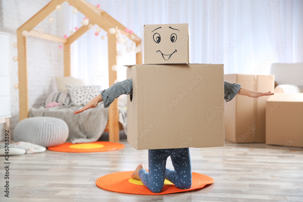 Fototapeta premium Cute little child wearing cardboard costume in bedroom
