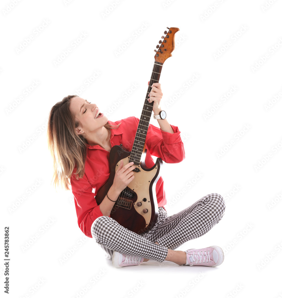 Fototapeta premium Young woman playing electric guitar on white background
