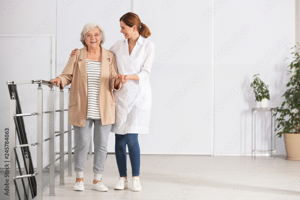 Elderly woman with caregiver indoors. Space for text Elderly woman with caregiver indoors. Space for text