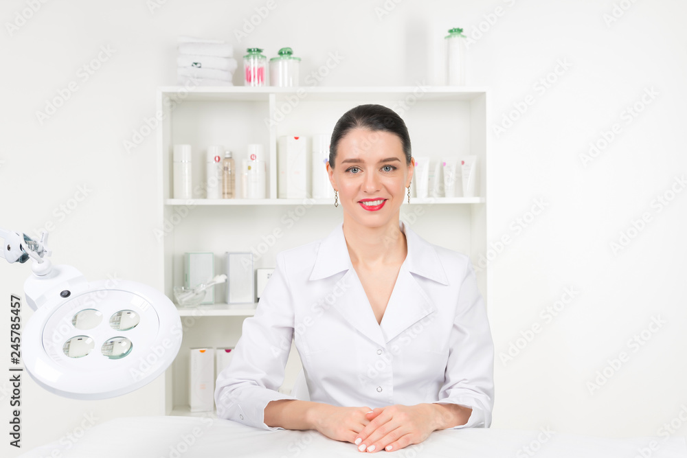 Woman beautician doctor at work in spa center. Portrait of a young female professional cosmetologist. Female employee in cosmetology cabinet or beauty parlor. Healthcare occupation, medical career Woman beautician doctor at work in spa center. Portrait of a young female professional cosmetologist. Female employee in cosmetology cabinet or beauty parlor. Healthcare occupation, medical career