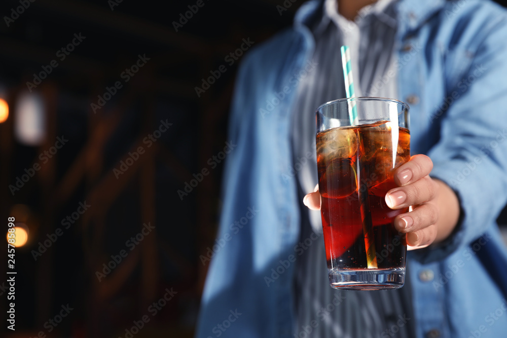 Woman with glass of refreshing cola indoors, closeup. Space for text Woman with glass of refreshing cola indoors, closeup. Space for text