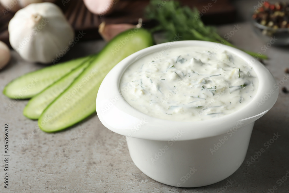 Cucumber sauce in ceramic bowl on table. Traditional Tzatziki Cucumber sauce in ceramic bowl on table. Traditional Tzatziki