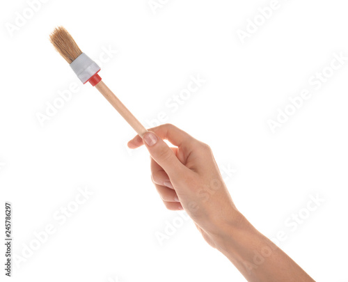 Woman holding paint brush on white background  closeup