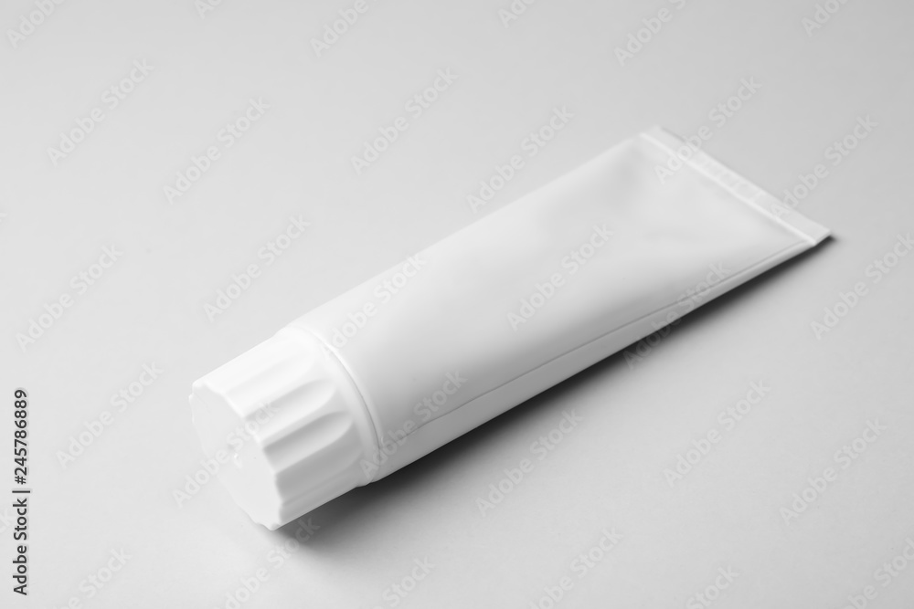 Blank tube of toothpaste on white background