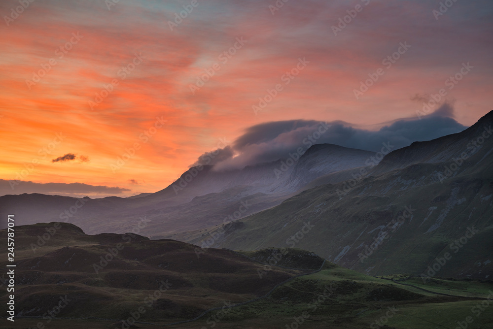 Beautifuk vibrant landscape image of mountains around Cregennen Lakes in Snowdonia on Winter sunrise morning