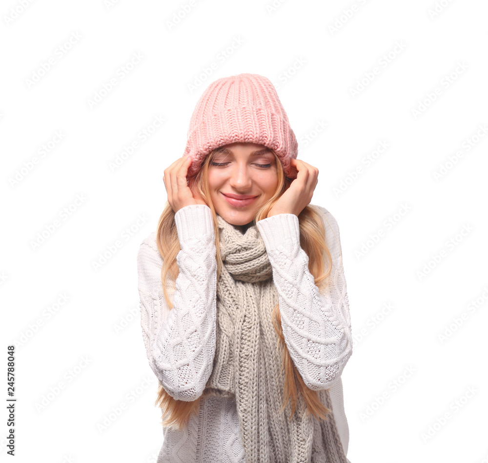 Portrait of emotional young woman in stylish hat and sweater with scarf on white background. Winter atmosphere Portrait of emotional young woman in stylish hat and sweater with scarf on white background. Winter atmosphere