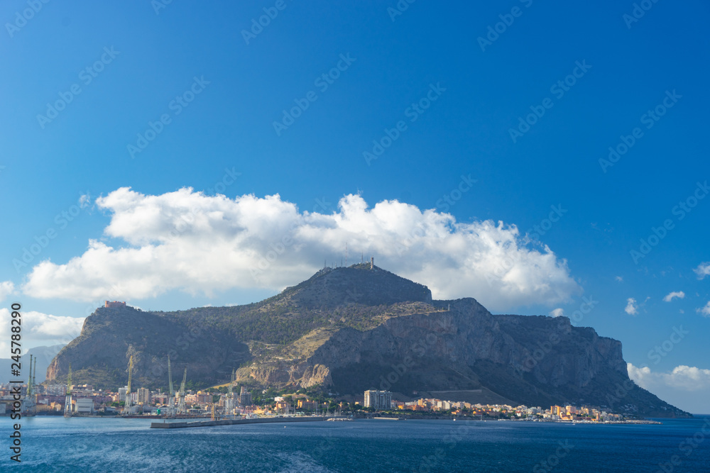 Aerial view from the sea of Palermo with mountains and clouds on background