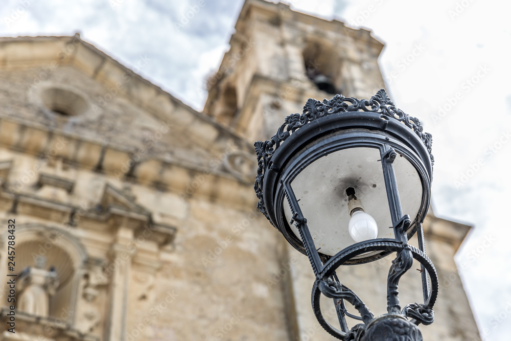 Close up view of a street lamp with a background church Close up view of a street lamp with a background church