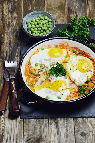 Delicious Shakshuka on the wooden background. Healthy eggs breakfast 