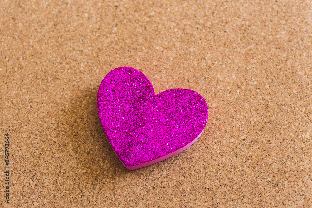 Top view of a velvet heart shape over a craft background Top view of a velvet heart shape over a craft background