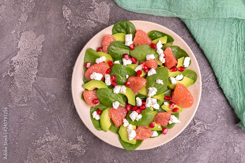 Tasty salad with grapefruit, spinach, feta, avocado and pomegranate