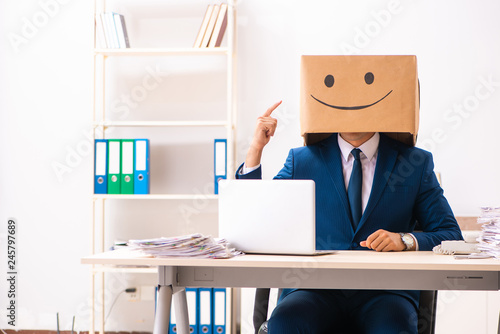 Happy man employee with box instead of his head