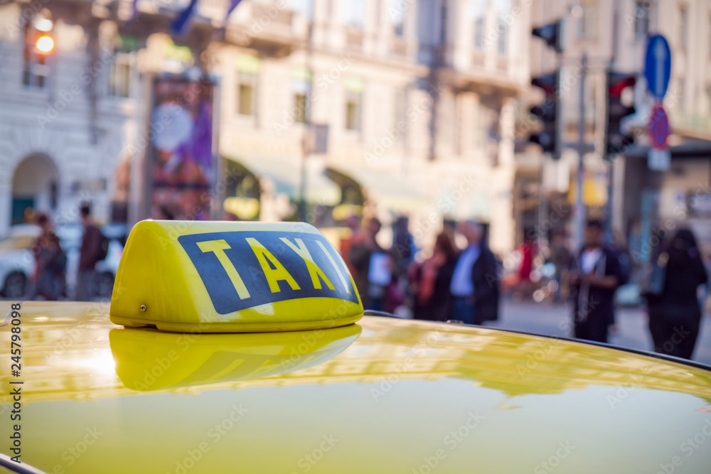 Sign taxi close-up on city background. Sign taxi close-up on city background.