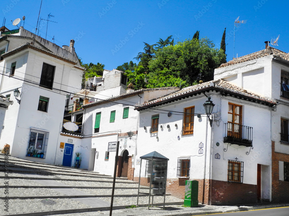 Albaicin, Old muslim quarter, district of Granada in Spain. White houses street.