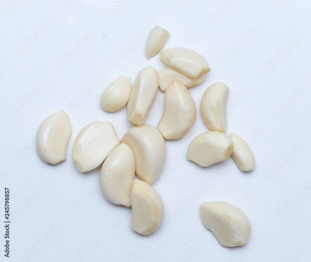 peeled garlic on a white background peeled garlic on a white background