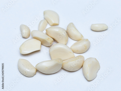peeled garlic on a white background