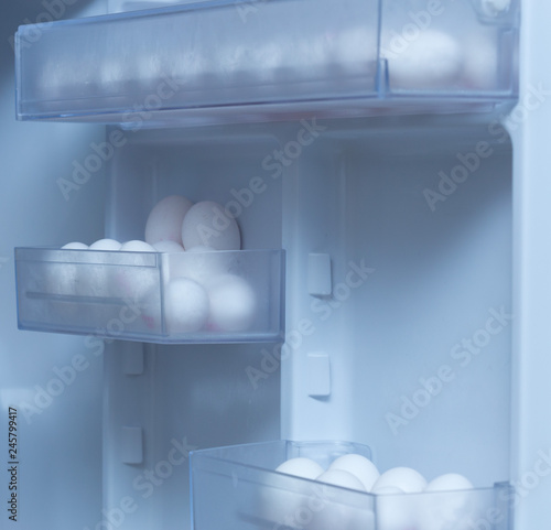 chicken eggs on a plastic tray in the fridge
