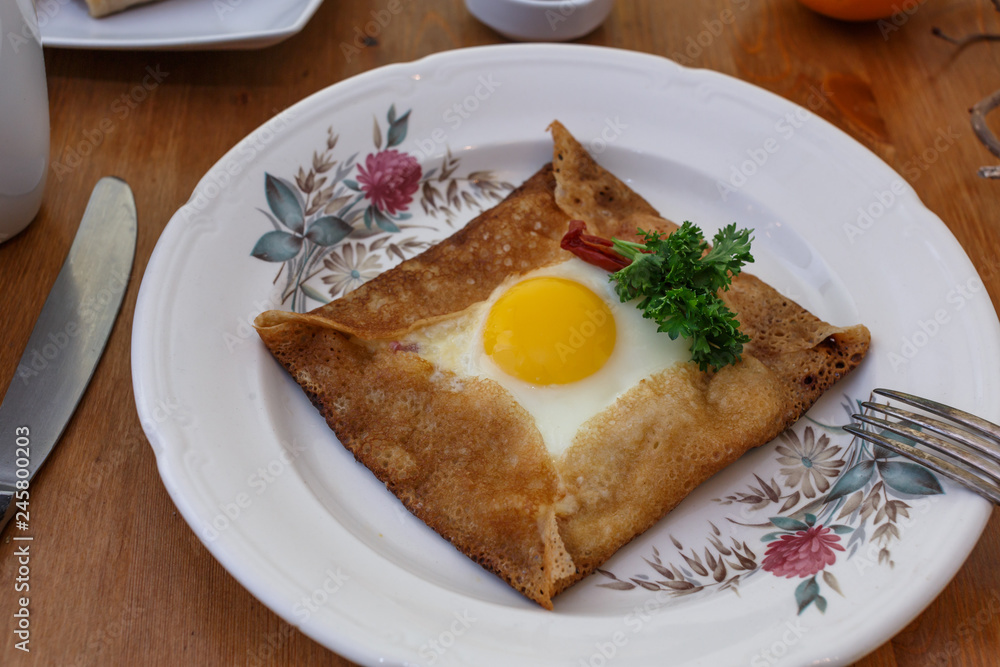 Galette sarrasin, buckwheat crepe, with ham cheese and egg, french brittany cuisine Galette sarrasin, buckwheat crepe, with ham cheese and egg, french brittany cuisine