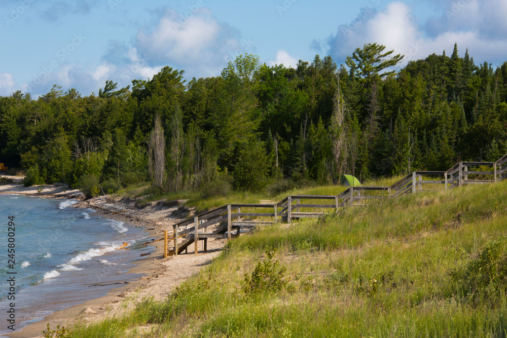 Beach and forest with a person camping on the water Beach and forest with a person camping on the water
