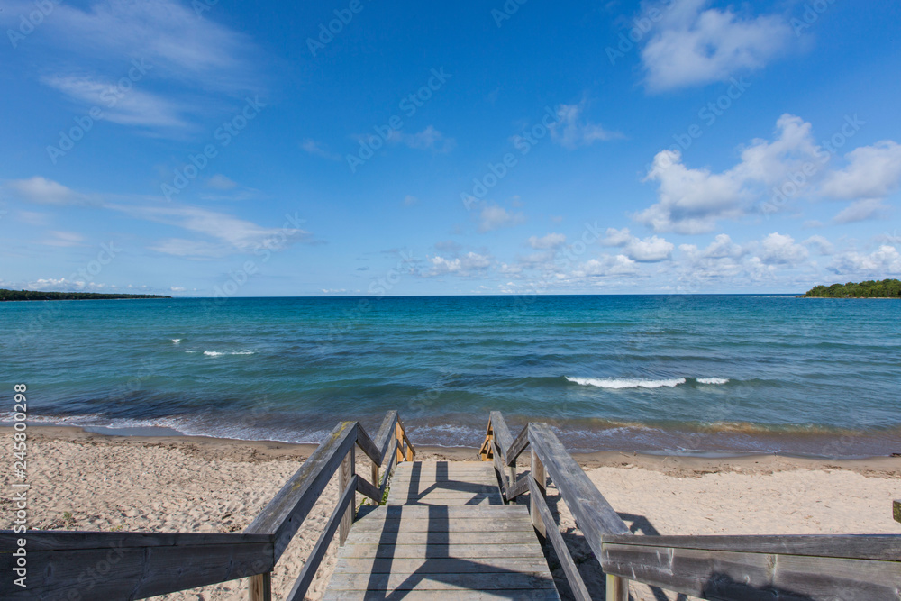 Fototapeta premium Stairs leading down to the water on a clear summer day