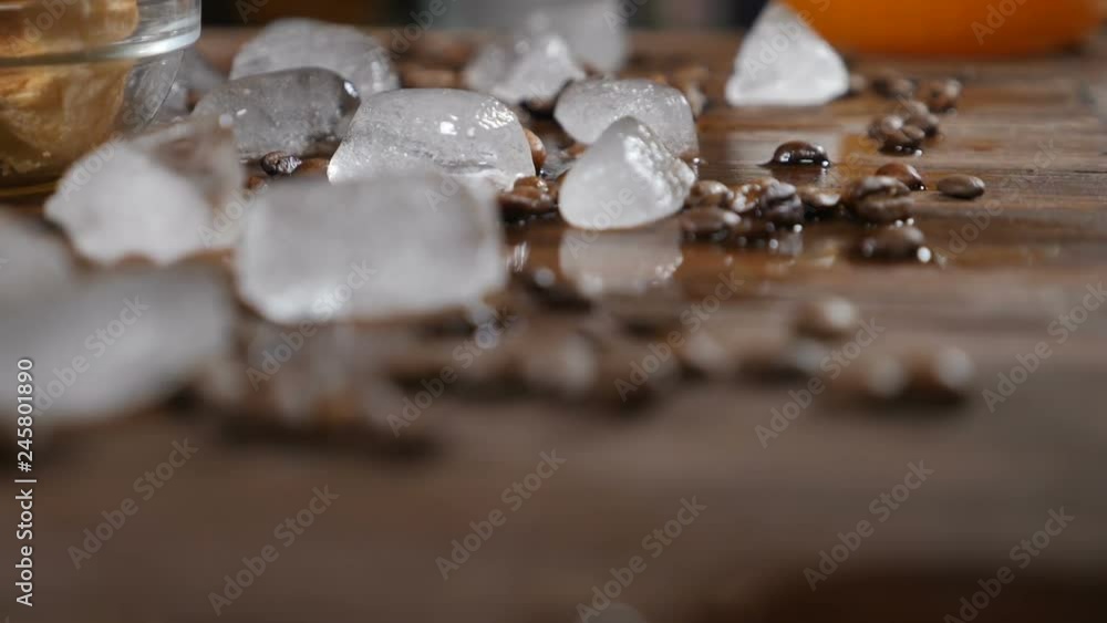 Coffee house concept. Ice cubes and coffee beans on wooden board. Food art. Delicious croissants on glass bowl on the background. hd Coffee house concept. Ice cubes and coffee beans on wooden board. Food art. Delicious croissants on glass bowl on the background. hd