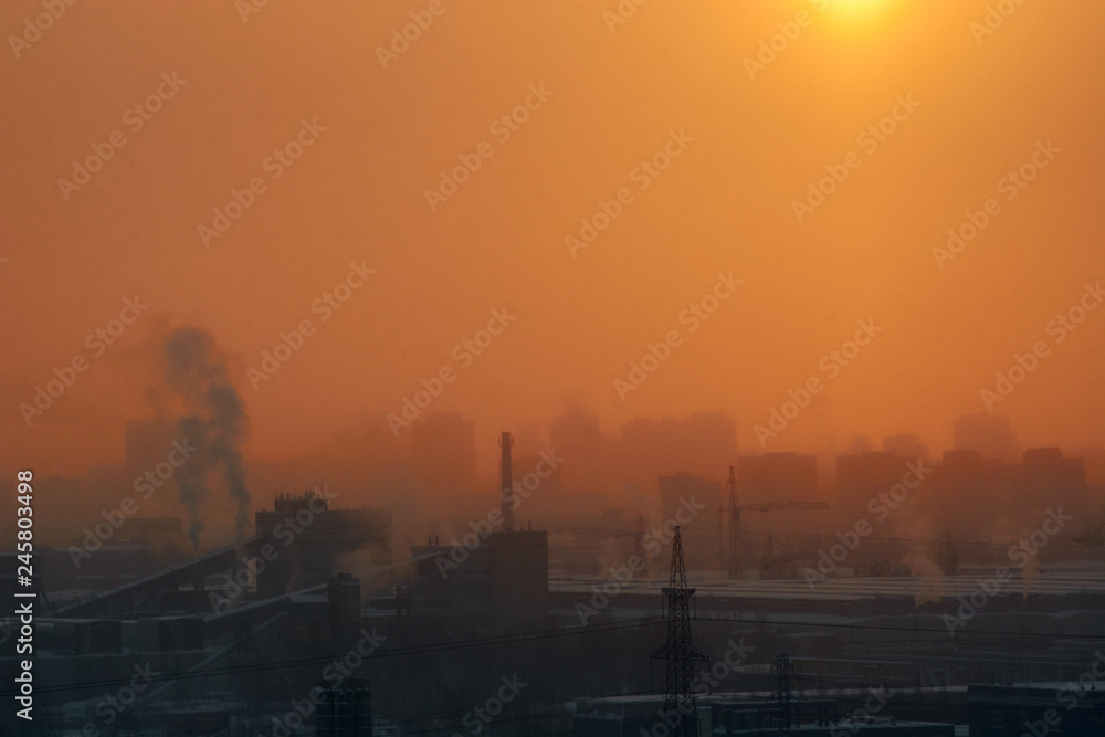 dawn in the city in the winter among high-rise buildings