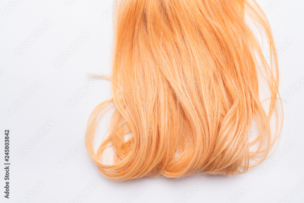 Human, natural honey-colored blond hair on white isolated background.  Stylish, fashionable colors this year. Honey blonde shaken, wave and  undulating hair. An example of hairstyle. Stock Photo | Adobe Stock