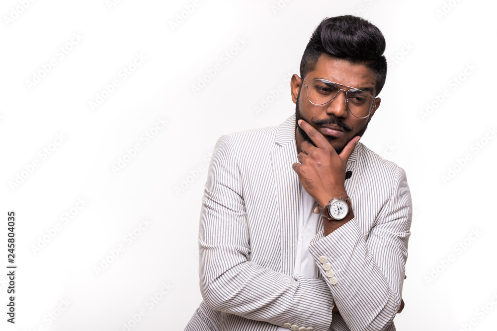 Young Indian hipster Confused Man Scratching His Chin isolated white background Young Indian hipster Confused Man Scratching His Chin isolated white background