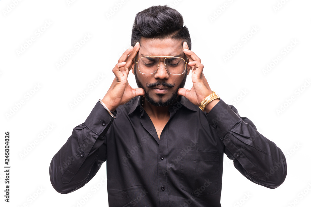 Young stressed hipster Indian man having headache isolated on white background Young stressed hipster Indian man having headache isolated on white background