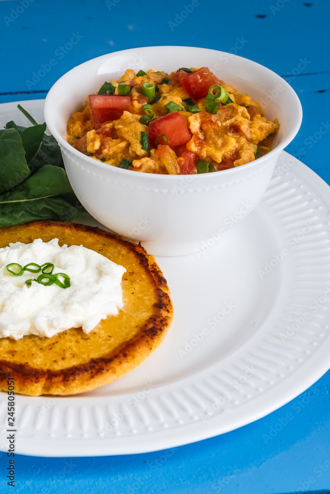 Traditional colombian breakfast huevos pericos with corn cakes Traditional colombian breakfast huevos pericos with corn cakes