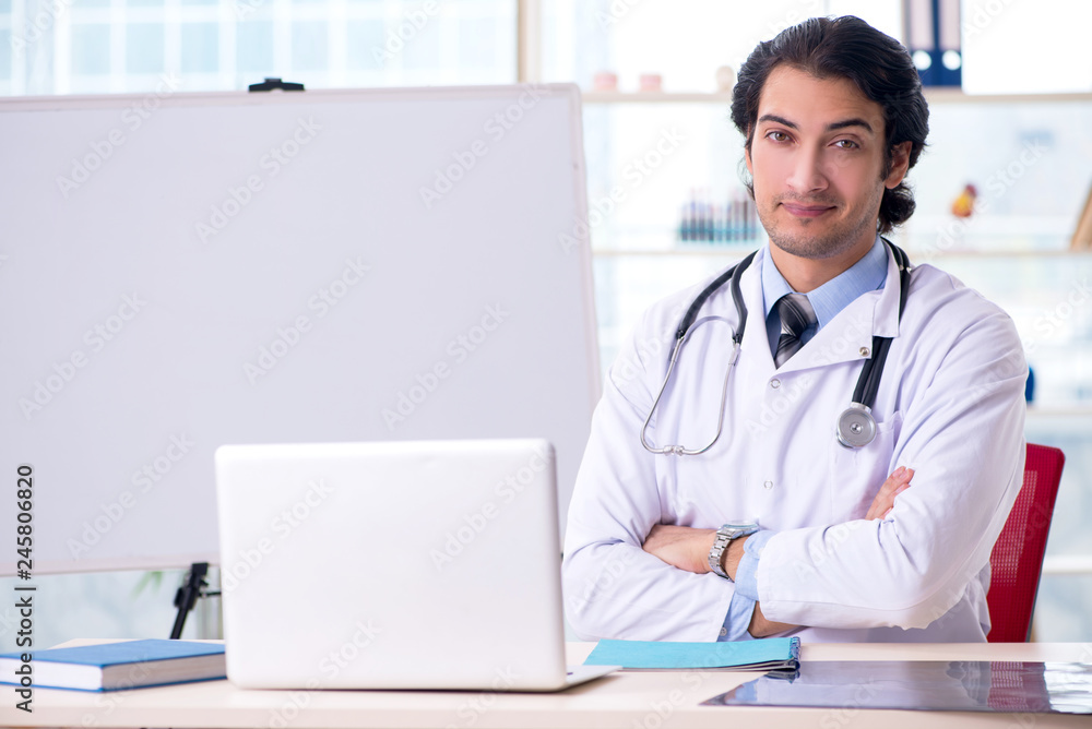 Young handsome doctor in front of whiteboard Young handsome doctor in front of whiteboard