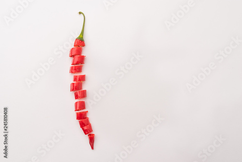 Fresh hot chili pepper isolated on white background. Sliced red peppers. Free copy space. Hot spice as an addition to many dishes.