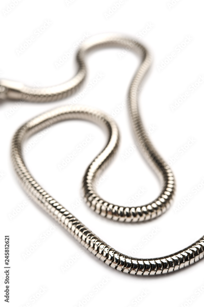 Fototapeta premium Silver chain on white background. Focus on foreground.