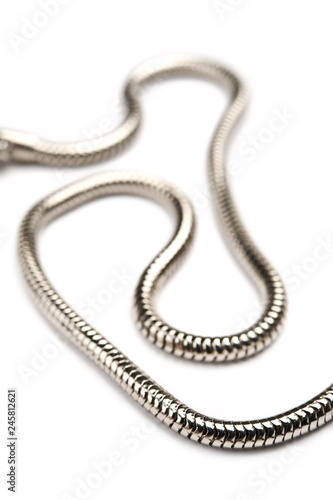 Silver chain on white background. Focus on foreground.