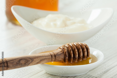 Fresh honey and milk yogurt in porcelain tableware