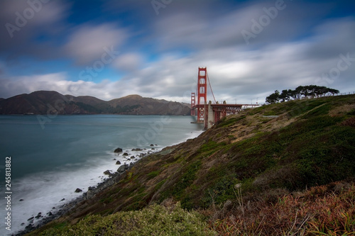 Golden Gate bridge long exposure from west side  featuring clouds and the ocean of the bay 