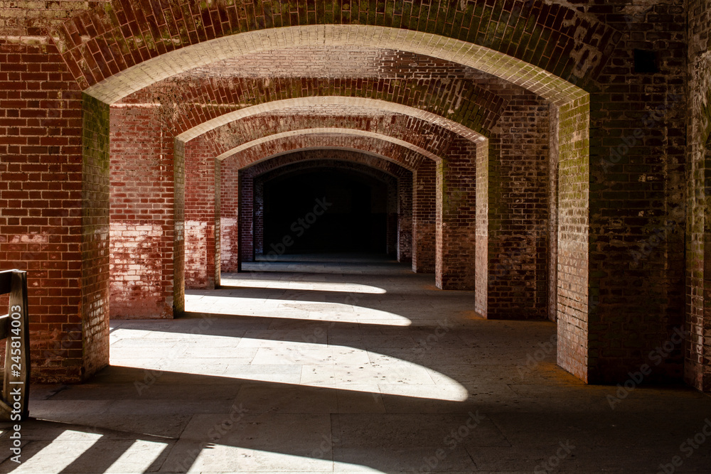 The brick walls covered in moss and corridors of Fort Point, a tourist attraction and old fortification in San Francisco, CA, USA