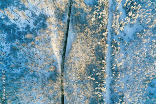 Aerial view on the road and forest at the winter time.