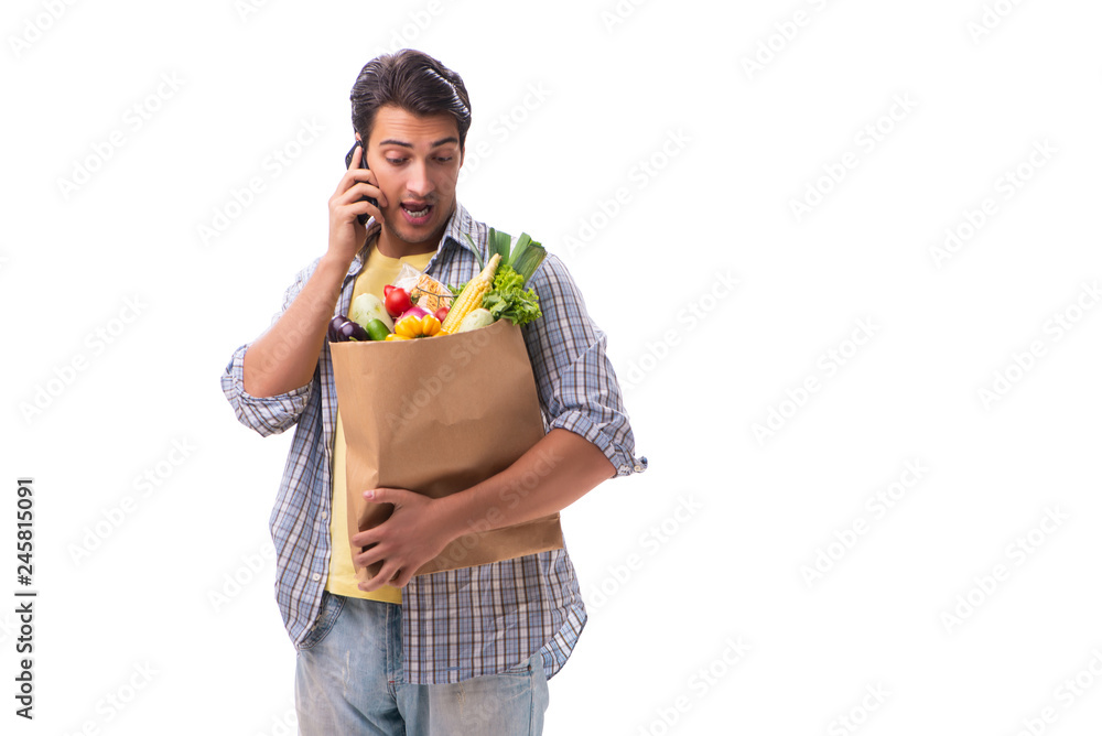 Young man with his grocery shopping on white Young man with his grocery shopping on white