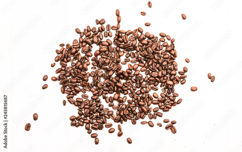 Fried brown coffee beans are scattered Fried brown coffee beans are scattered