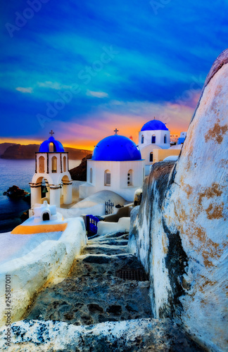Picturesque view of Old Town Oia on the island Santorini, white houses, windmills and church with blue domes, Greece